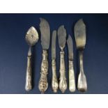 Three antique silver butter knives together with a further silver bladed fruit knife, a further