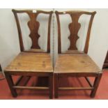 A pair of Georgian Countrymade side chairs in elm, with vase shaped splats and solid seats