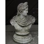 A weathered cast composition stone head and shoulder bust of a classical character set on a
