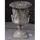 A small weathered Georgian style cast composition stone campana shaped garden urn with flared rim