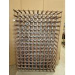 A wine rack to hold 150 bottles with pine divisions and strap work frame, 100 cm x 150 cm