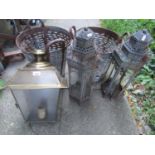 Two weathered Eastern tin candle lanterns of hexagonal form with glazed panels and decorative