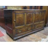 A Georgian oak mule chest - the rising lid over four rectangular fielded panels and two frieze