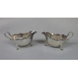 Pair of Georgian style boat shaped saucer boats, with cast banded borders and hoof feet, maker