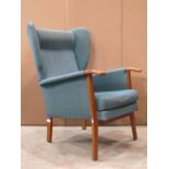 A Remploy mid 20th century shallow wing back armchair with upholstered finish, loose seat cushion