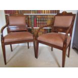 A pair of late 19th century mahogany elbow chairs with trailing floral marquetry detail, raised on