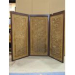 A three fold floor standing screen with cruel work floral panels, mahogany frame with moulded