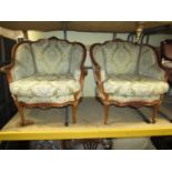 A pair of open French armchairs with carved and moulded show wood frames, upholstered finish and