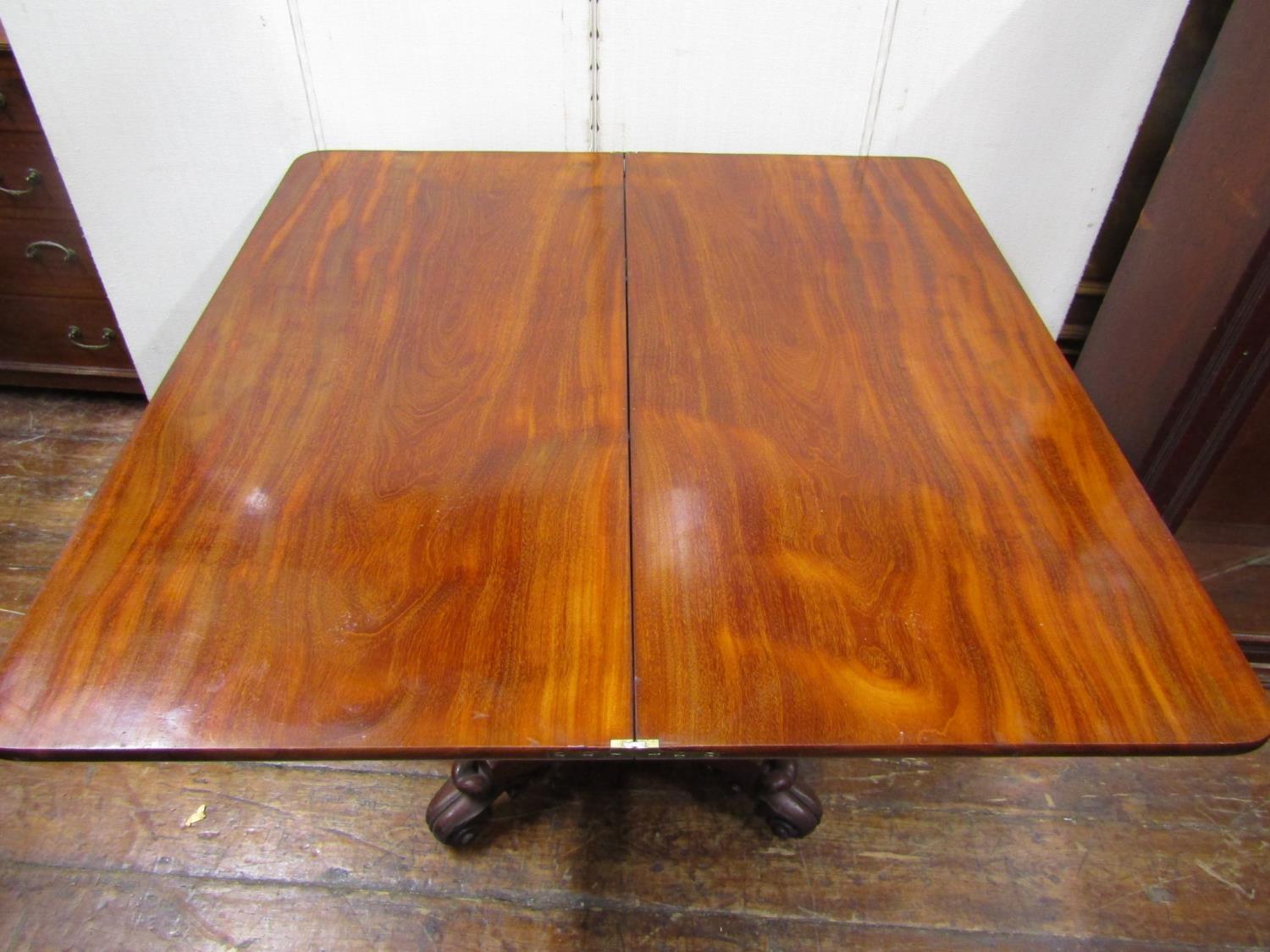 A Regency mahogany fold over top tea table, raised on a vase shaped pillar and platform base, with - Image 3 of 3