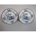 A pair of 18th century Delft plates with polychrome painted decoration in the