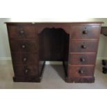 A Victorian mahogany kneehole twin pedestal desk fitted with eight drawers with well matched flame