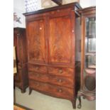 An early 19th century mahogany linen press with moulded and dentil cornice over a pair of