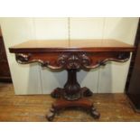 A Regency mahogany fold over top tea table, raised on a vase shaped pillar and platform base, with