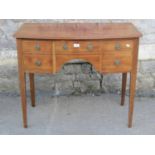 A Georgian style mahogany bow fronted side table, the top with reeded outline over an arrangement of