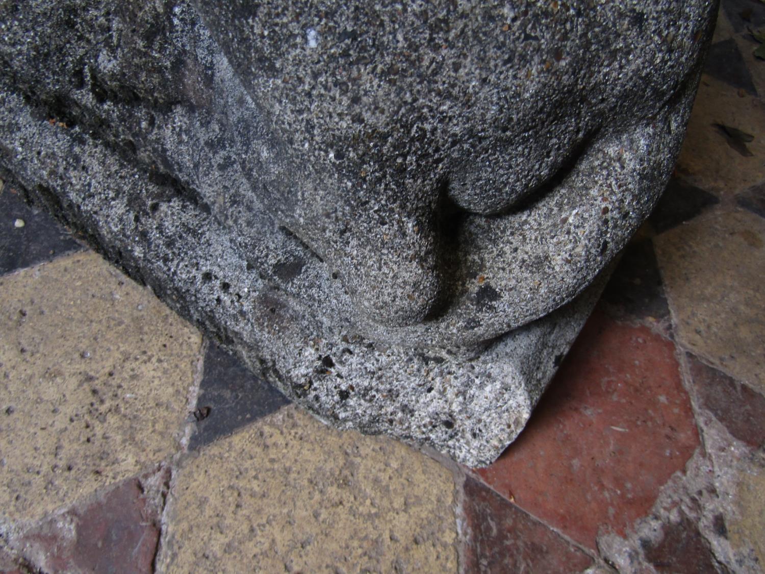 A pair of weathered hollow cast composition stone recumbent regal lions with defined features, 70 cm - Image 3 of 4