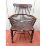 A late 19th century office chair with dished seat in a stick work framework with turned spindle