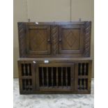 A good quality Old English style oak hanging cupboard with distressed finish and of stepped form