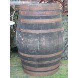 A coopered oak and steel banded cider barrel, 126 cm high