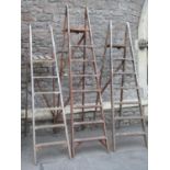 Three vintage wooden folding step ladders of varying height and design, but all with reeded