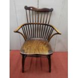 Early Georgian Windsor stick back elbow chair in mixed woods with dished elm seat, turned supports