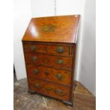 A small Sheraton style ladies writing bureau fitted with four long drawers, the fall flap
