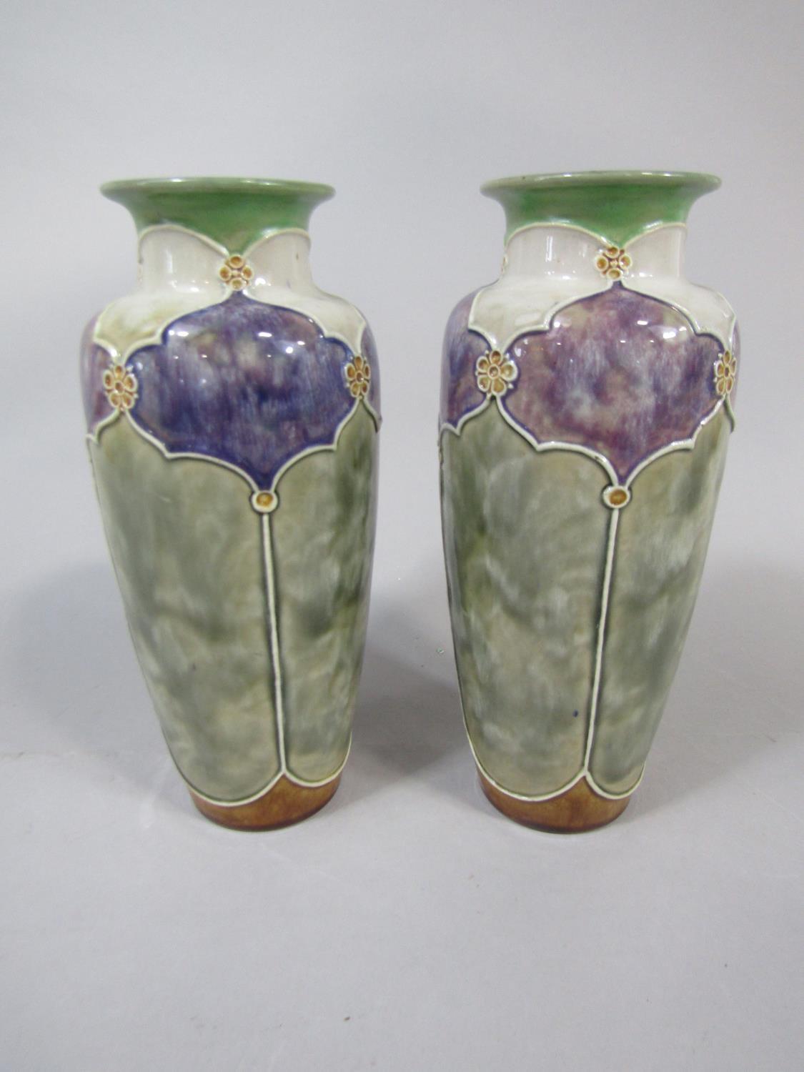 A pair of Royal Doulton vases with purple and white mottled glaze reserve panels on a green