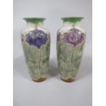 A pair of Royal Doulton vases with purple and white mottled glaze reserve panels on a green