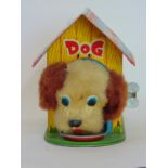 Tinplate clockwork nodding dog in kennel, eats from bowl when wound