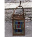 A Victorian hall or porch lantern of square form with leaded light panels an pierced detail