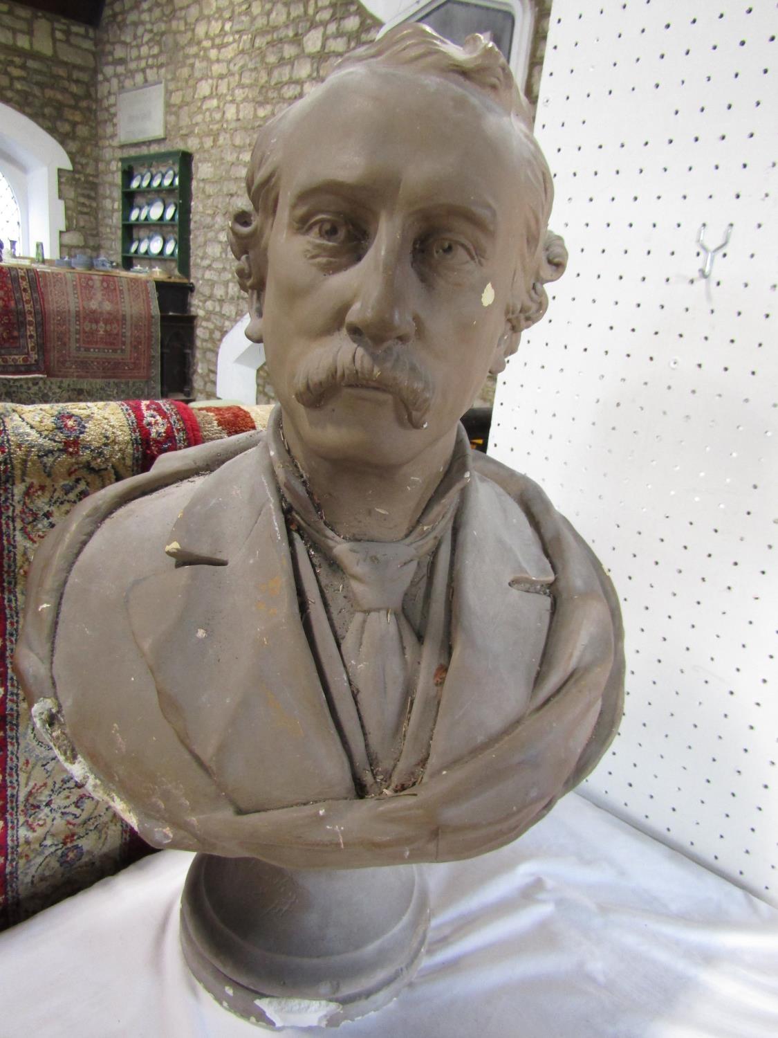 A plaster bust of an Edwardian moustached gentleman wearing a shirt and tie, the plinth base