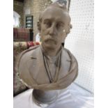 A plaster bust of an Edwardian moustached gentleman wearing a shirt and tie, the plinth base