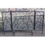 An ironwork folding fire screen/guard with scroll detail and flattened pyramid finials, 107 cm