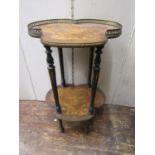 A Victorian two tier marquetry occasional table, with clover leaf panels, brass mounts and raised on