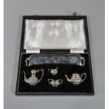 A good quality cased five piece miniature silver half fluted tea service, comprising tea pot,