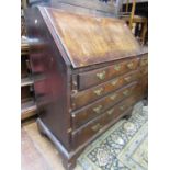 18th century walnut veneered bureau of four long drawers with crossbanded borders, raised on bracket