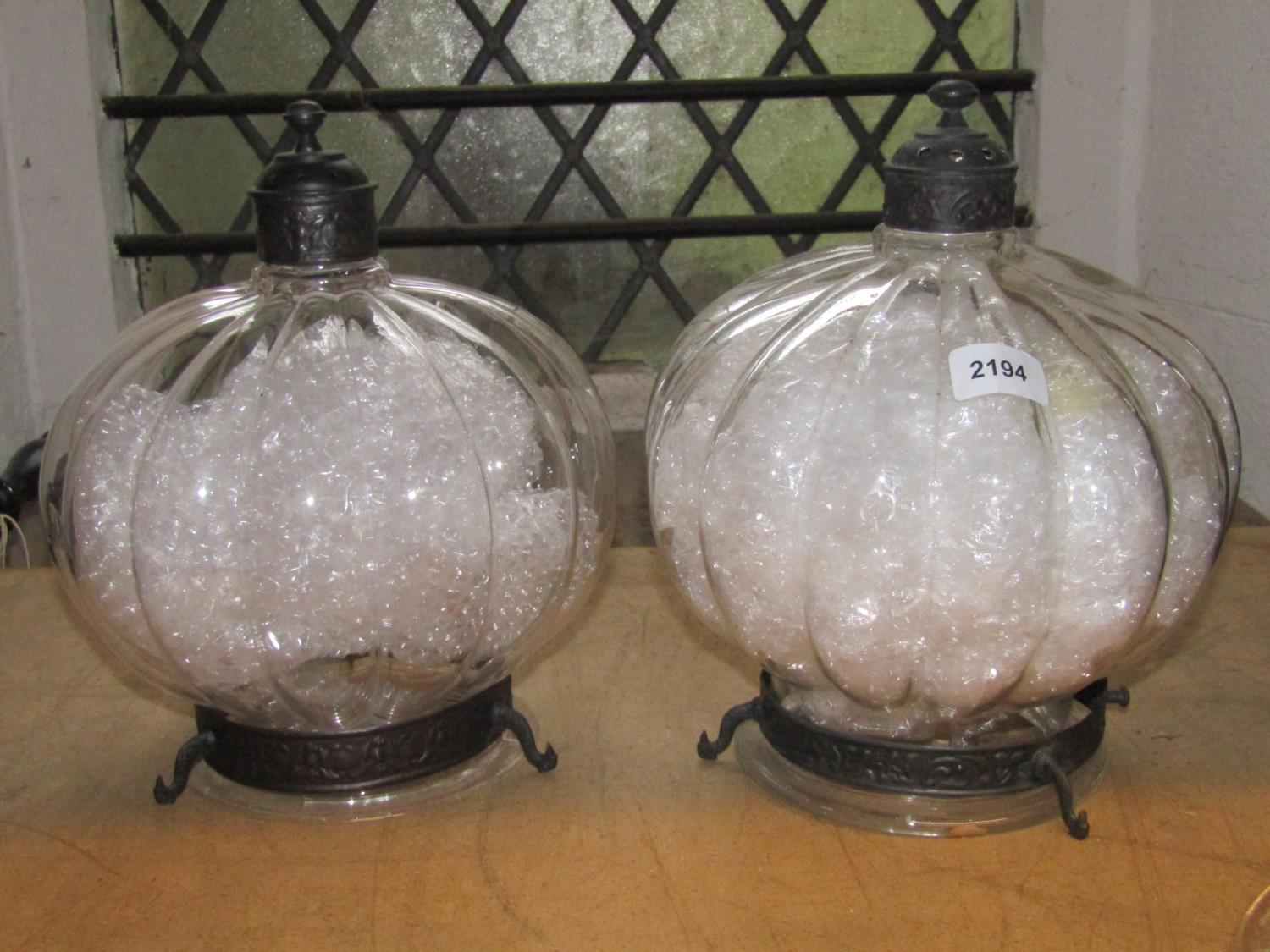 A pair of contemporary moulded glass pumpkin shaped hanging ceiling lights with metal fittings,