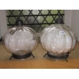 A pair of contemporary moulded glass pumpkin shaped hanging ceiling lights with metal fittings,