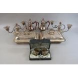 A mixed collection of white metal and silver plate comprising a cased pair of 800 silver napkin