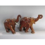A pair of eastern carved wooden elephants, 32cm high