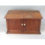 A late 19th century mahogany table top cabinet with moulded top and two hinged doors, 42cm wide