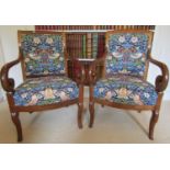 A pair of 19th century mahogany scroll armed elbow chairs on shaped forelegs, upholstered in William