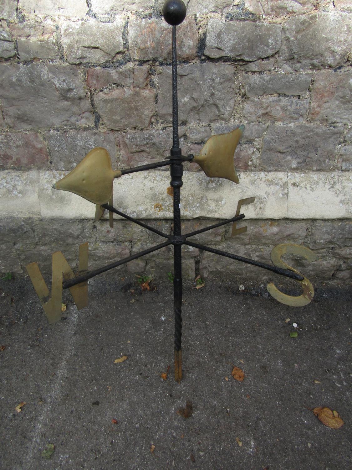 An ironwork weather vane with painted gilt highlighted metal letters and copper arrow head pointer