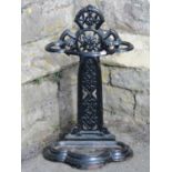An unusual Victorian cast iron umbrella stand, the back in the form of a medieval cross with pierced
