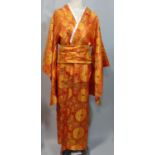 Japanese Kimono in red and gold with Obi sash and bow in good condition together with a snakeskin