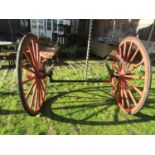 A pair of 19th century horse carriage/trap wheels and combined axle and springs with iron hubs, 16