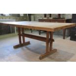 A stripped pine refectory table, the thick rectangular top with rounded corners raised on