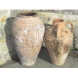 An old buff coloured terracotta oviform jar with incised detail, a 57 cm high approximately,