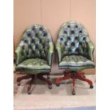 A pair of reproduction buttoned green leather upholstered spoon back swivel and adjustable office