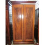 A Victorian mahogany wardrobe with moulded cornice over a pair of full length rectangular moulded