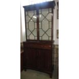 A 19th century mahogany two sectional side cabinet, the upper with dentil and reed moulded cornice